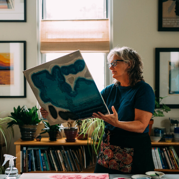 Mary Brodbeck holds a woodblock in her studio